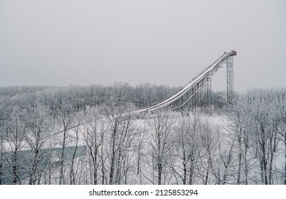 Ski Jumping Slopes Or Towers In Tatarstan, Russia. Ramps Surrounded By Snow-covered Trees On A Hill . Ski Jumping Ramp