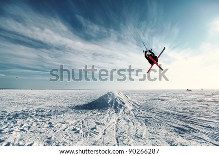 Ski kiting and jumping on a frozen lake