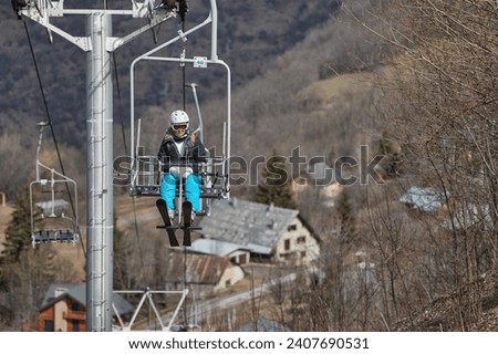 Ski lift in the Alps with lack of snow after heavy melting, complete lack of snow in the lower section of the ski resort Les 2 Alpes