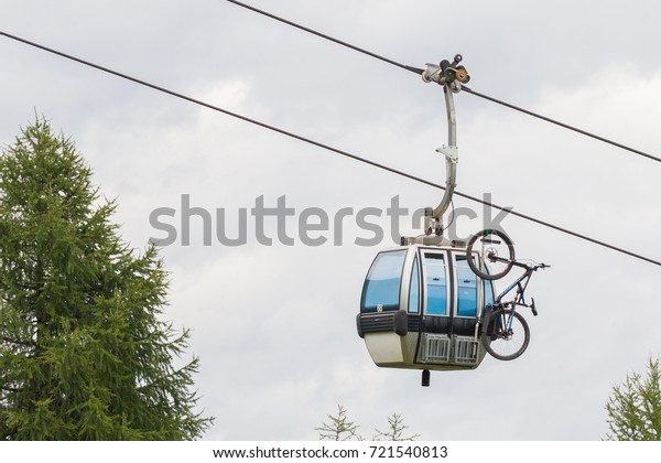 Ski lift cable booth or car with a\
mountainbike on the side (unmarked), Austria in\
summer