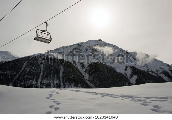A ski lift and a cable car in the alps switzerland
in winter