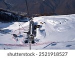 ski lift gondolas against blue sky over slope at ski resort on sunny winter day