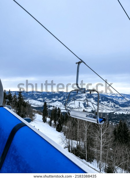 Ski Lift snowy mountain
winter forest with chair lift At The Ski Resort in winter. Snowy
weather Ski holidays Winter sport and outdoor activities Outdoor
tourism 