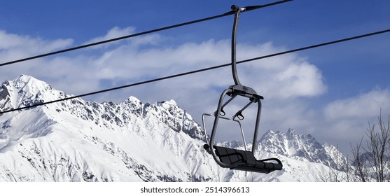 Ski lift in snowy winter mountains at nice sunny day. Caucasus Mountains. Hatsvali, Svaneti region of Georgia. Panoramic view. - Powered by Shutterstock