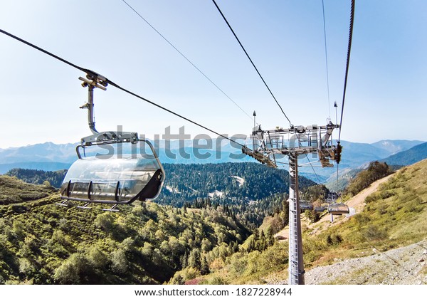 Ski lift with supports and chairs in the mountains\
on summer