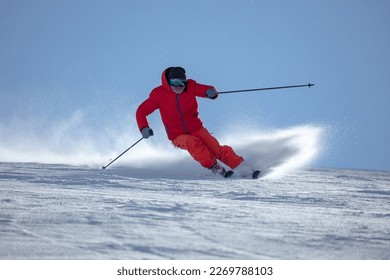 Ski man. Skiing sport. Front view. In action. Sportsman in a red ski suit. - Shutterstock ID 2269788103