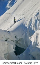 Ski mountaineer climbs a steep, dangerous glacier with large berghrunds and cracks. Alps, Mont Maudit