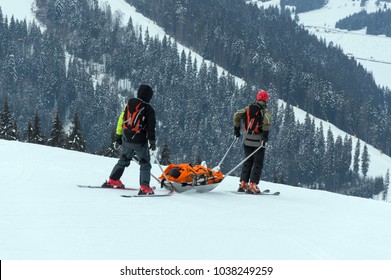 Ski patrol team rescue injured skier with the special emergency sledges in the Carpathian mountains region - Powered by Shutterstock