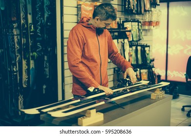 Ski Repair Shop Worker Adjust The Bindings And Equipment. Winter Workshop Service