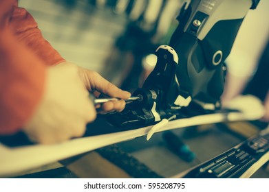 Ski Repair Shop Worker Adjust The Bindings And Equipment. Winter Workshop Service