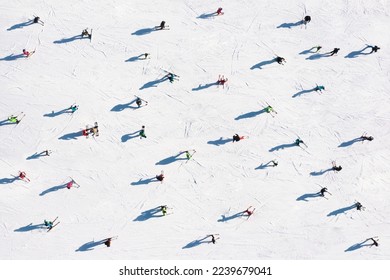 Ski resort. Aerial view of skiers. Winter sports. Snow slope in the mountains for sports. Group training. Exercise with friends. winter landscape from a drone.