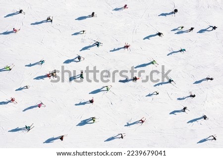 Ski resort. Aerial view of skiers. Winter sports. Snow slope in the mountains for sports. Group training. Exercise with friends. winter landscape from a drone.