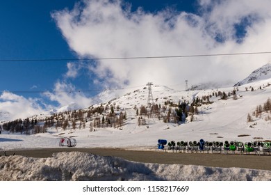 Ski resort in Bernina alps with a lot of snowcannons and with a blue sky with some clouds in background, picture from Swizerland.