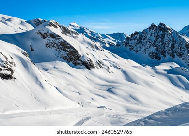 Ski run in winter resort with mountains in background, Loetschental valley, Switzerland - Powered by Shutterstock