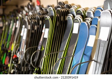 Ski shop sale. Rows of colourful alpine skis in modern sport equipment store