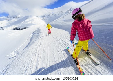 Ski, skiers on ski run - child skiing downhill