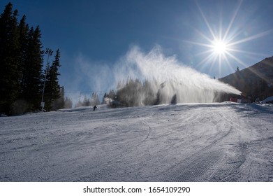 Ski Slope With Artificial Snow Machine And Skiers