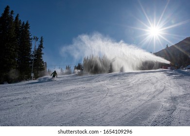 Ski Slope With Artificial Snow Machine And Skiers