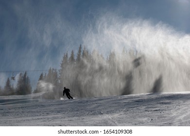 Ski Slope With Artificial Snow Machine And Skiers