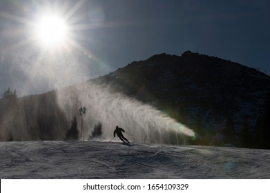 Ski Slope With Artificial Snow Machine And Skiers