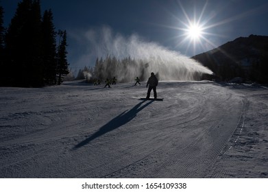 Ski Slope With Artificial Snow Machine And Skiers