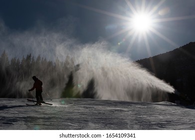 Ski Slope With Artificial Snow Machine And Skiers