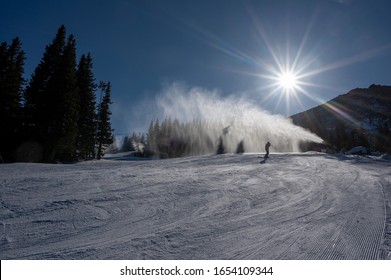 Ski Slope With Artificial Snow Machine And Skiers