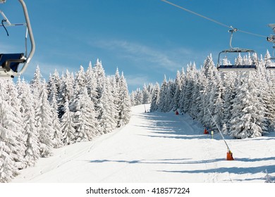 Ski slope with ski lifts and snow cannons