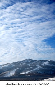 Ski slope under the light cloudy sky