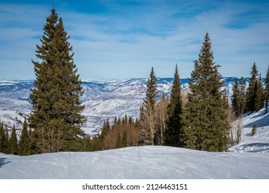 The Ski Slopes Of The Aspen Snowmass Ski Resort, In The Rocky Mountains Of Colorado, Are Lined By Aspen Trees And Pine Trees