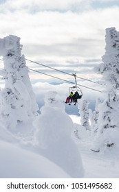 Ski Or Snowboard On Chairlift At Big White Resort, Kelowna, British Columbia, Canada