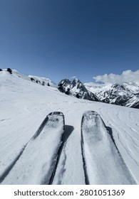 The ski tips of a single ski tourer heading towards the peaks of the Aiguilles Rouges in Chamonix in France