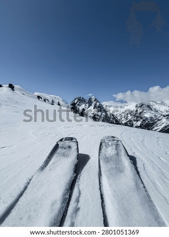 The ski tips of a single ski tourer heading towards the peaks of the Aiguilles Rouges in Chamonix in France