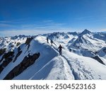 Ski tour to the summit of Flüela Wisshorn above Davos in a wonderful mountain world. Ski mountaineering in the Swiss Davos Klosters Mountains. Skitour in the snow covered mountains.