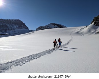 ski touring in deep snow on the glacier. Mountaineering on the Clariden in the Swiss mountains from Gemsfairenstock