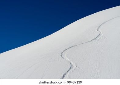Ski trace in the snow with blue sky