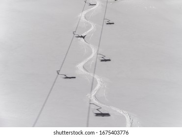 Ski track in deep snow with shadows from a chair lift, Venet, Zams, Tyrol, Austria