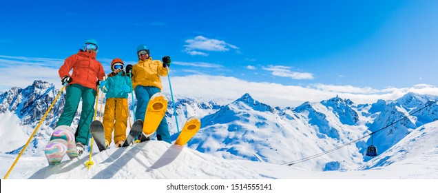 Ski in winter season, mountains and ski touring equipments on the top in sunny day in France, Alps above the clouds.