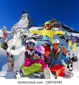 Ski, winter, snow - family enjoying winter vacation in Zermatt, photo manipulation: Only four model releases are needed - the same child on the photo. - Shutterstock ID 258731945