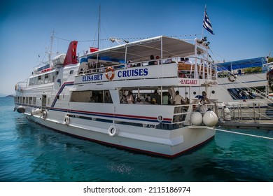 Skiathos, Greece- Avg 10, 2019. Touristic boat tour anchored at the old harbour in Skiathos Island ,Greece.