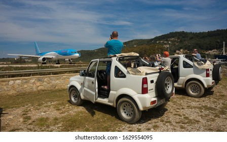 Skiathos, Greece - May 09, 2014, People Watching Airplane Preparing To Take Off On The Island Of Skiathos In Greece