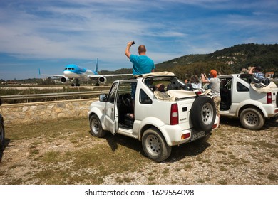 Skiathos, Greece - May 09, 2014, People Watching Airplane Preparing To Take Off On The Island Of Skiathos In Greece