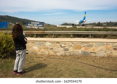 Skiathos, Greece - May 09, 2014, People Watching Airplane Preparing To Take Off On The Island Of Skiathos In Greece