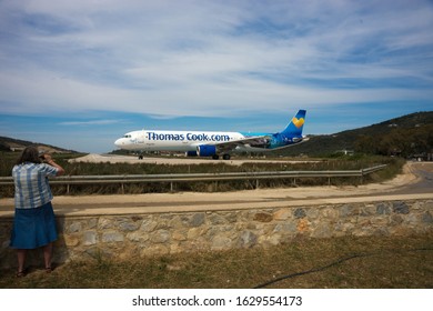 Skiathos, Greece - May 09, 2014, People Watching Airplane Preparing To Take Off On The Island Of Skiathos In Greece