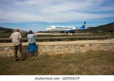 Skiathos, Greece - May 09, 2014, People Watching Airplane Preparing To Take Off On The Island Of Skiathos In Greece