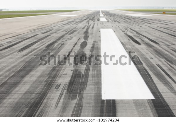 Skid\
marks on at the airport runway - selective\
focus
