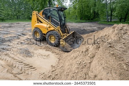 skid steer loader machine for earthmoving on construction site. earthmoving machine for leveling ground.