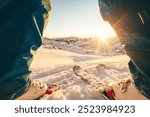 Skier athlete man standing in front of wonderful sunset in ski resort - Winter extreme sport concept with person on top of the mountain ready to ride down - Main focus on left boot