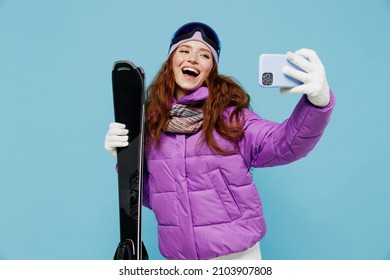 Skier Cool Woman In Warm Purple Windbreaker Jacket Goggles Mask Spend Extreme Weekend In Mountains Doing Selfie Shot On Mobile Cell Phone Post Photo Hold Ski Isolated On Plain Blue Background Studio