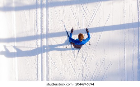 Skier cross-country skiing in snow forest. Winter competition, Aerial top view. - Powered by Shutterstock